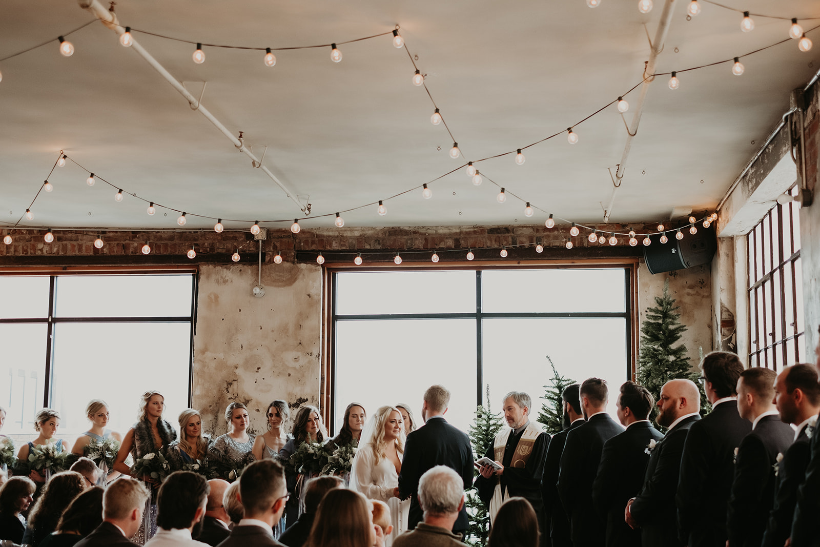 Winter Wedding Ceremony with String Lights, Bride and Groom at an Industrial Venue