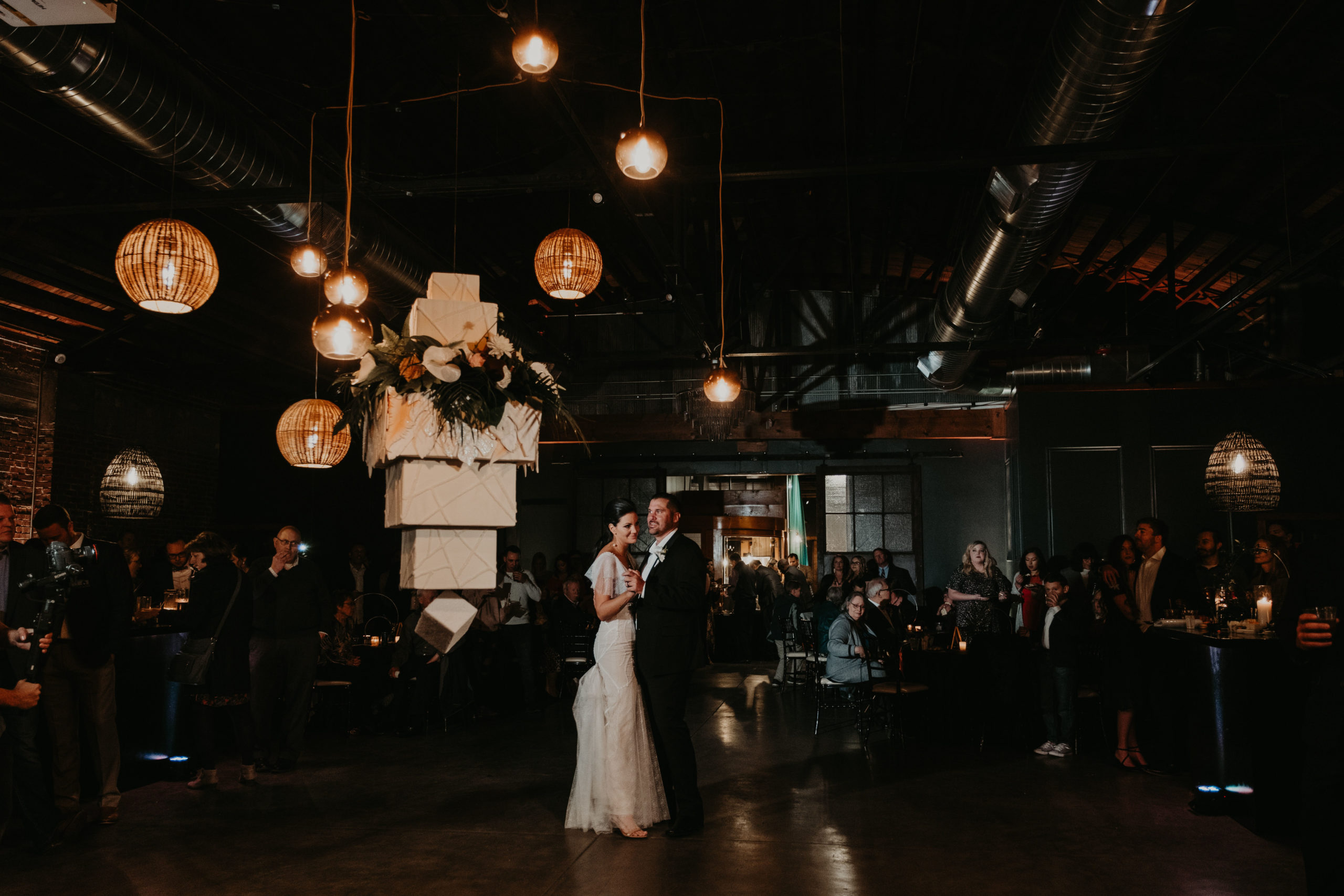 Bride and Grooms first dance next to floating cake
